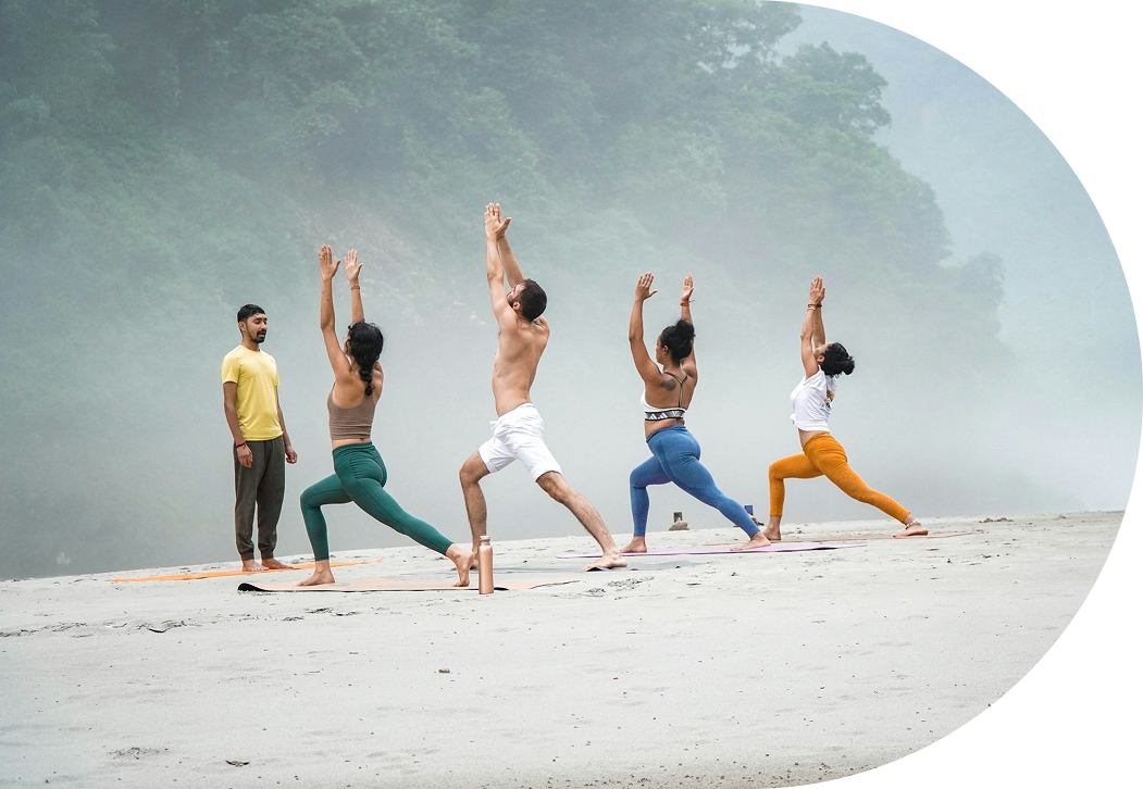 Group of people doing yoga on a beach
